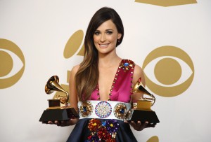 Country singer Kacey Musgraves poses backstage with her awards for Best Country Song for "Merry Go 'Round" and Best Country Album for "Same Trailer Different Park" at the 56th annual Grammy Awards in Los Angeles